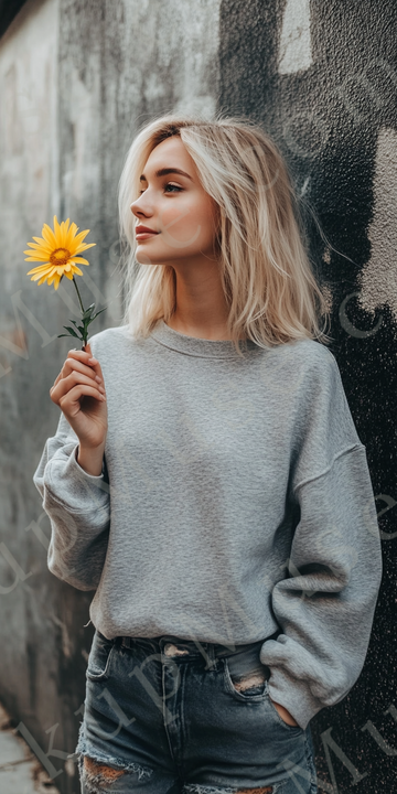 Womens grey sweatshirt mockup – lifestyle, outdoor holding yellow flower; Gildan 18000 fit