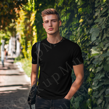 Men’s black Gildan 5000 crewneck t-shirt mockup — outdoor hedge, natural light portrait, front view