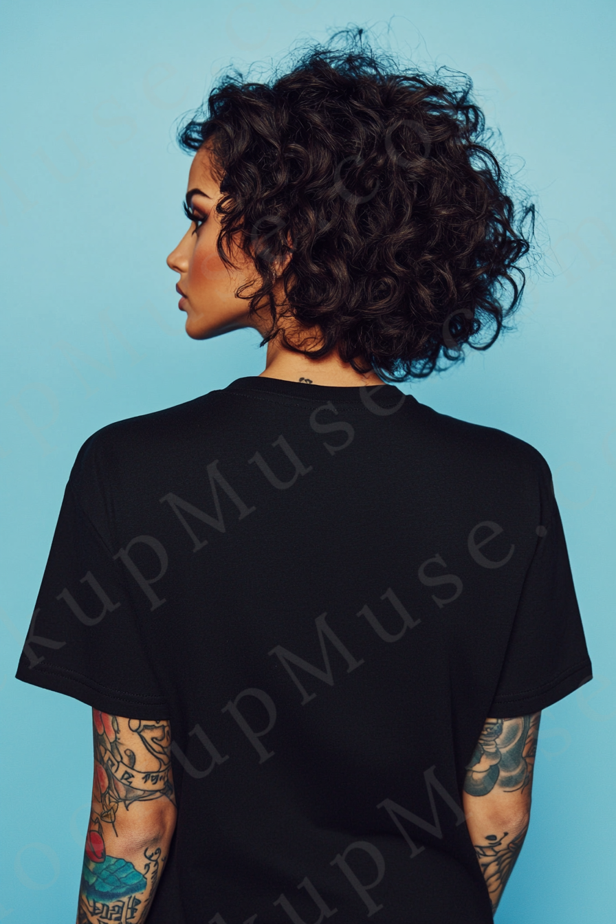 Vertical 2:3 women’s black onyx Gildan 5000 t‑shirt mockup, back view on teal studio with tattooed arms visible; clean apparel template for online stores.
